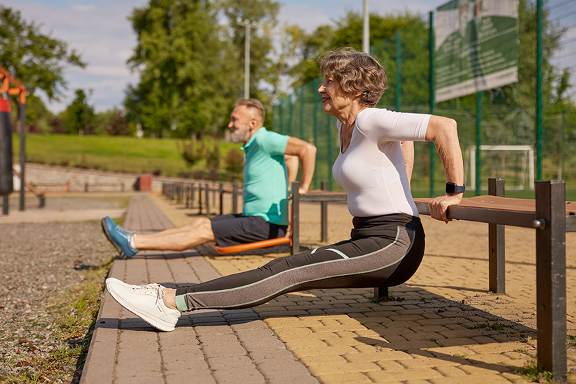 Happy sportive elderly couple training outdoors