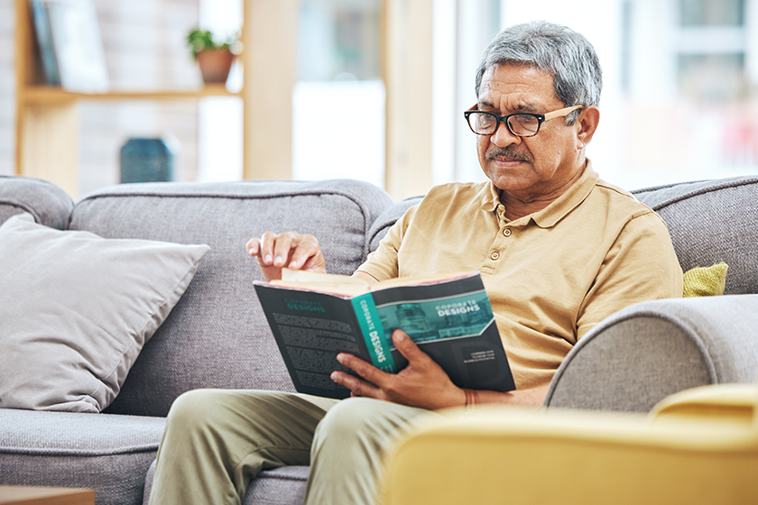 Home, relax and senior man with a book