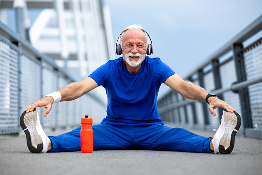 Senior athlete stretching legs and warming up body