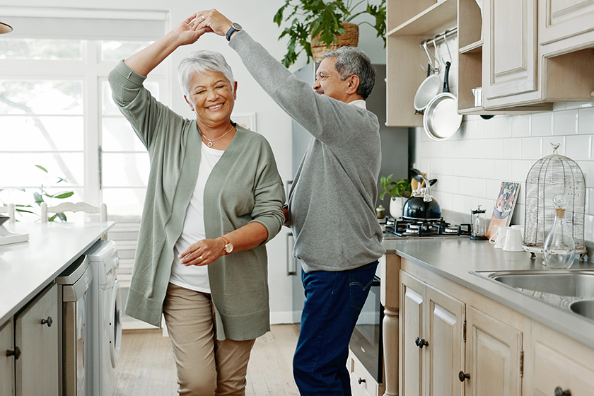 Elderly couple, dancing and love in home